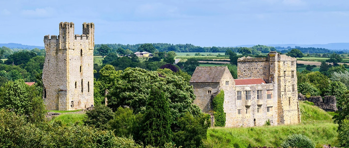 Helmsley Castle ruins set amongst lush green countryside in North Yorkshire